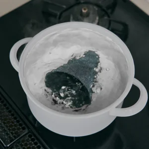 Cerapotta ceramic coffee filter being deep cleaned by boiling in water to remove buildup