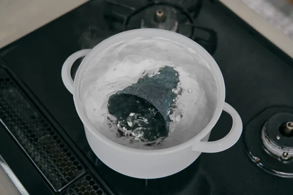 Cerapotta ceramic coffee filter being deep cleaned by boiling in water to remove buildup
