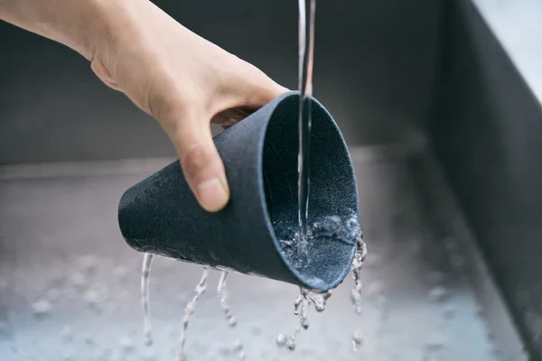 Hand rinsing the Cerapotta ceramic coffee filter under water to clean after use