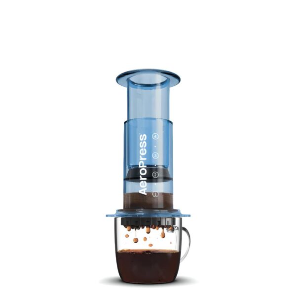 Blue AeroPress coffee maker brewing coffee in a glass mug
