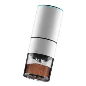 Joy Resolve Groove Compact Electric Grinder in white with coffee grounds in the container and LED light ring