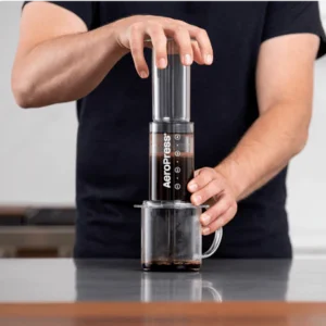 Pressing the AeroPress plunger to brew coffee.