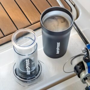 Aeropress Go Plus Travel System black tumbler with brewed coffee on a boat